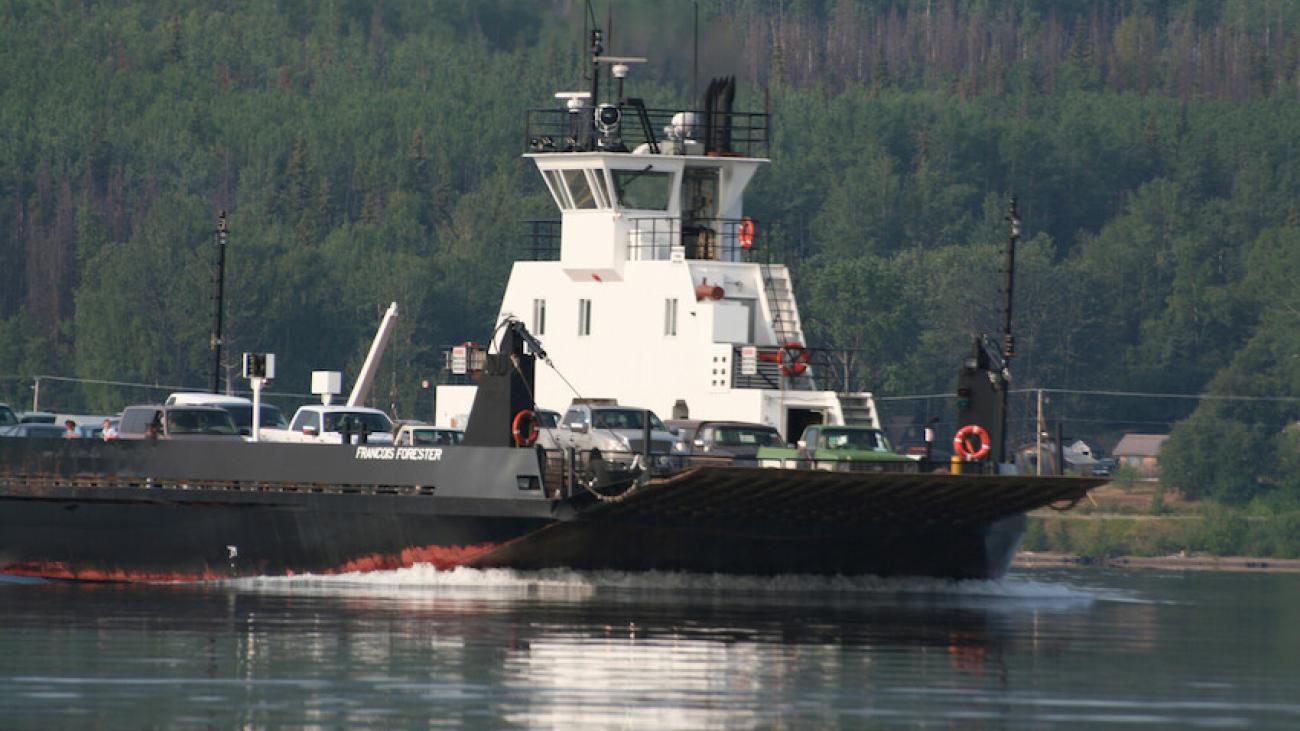 Ferry crossing a calm river.