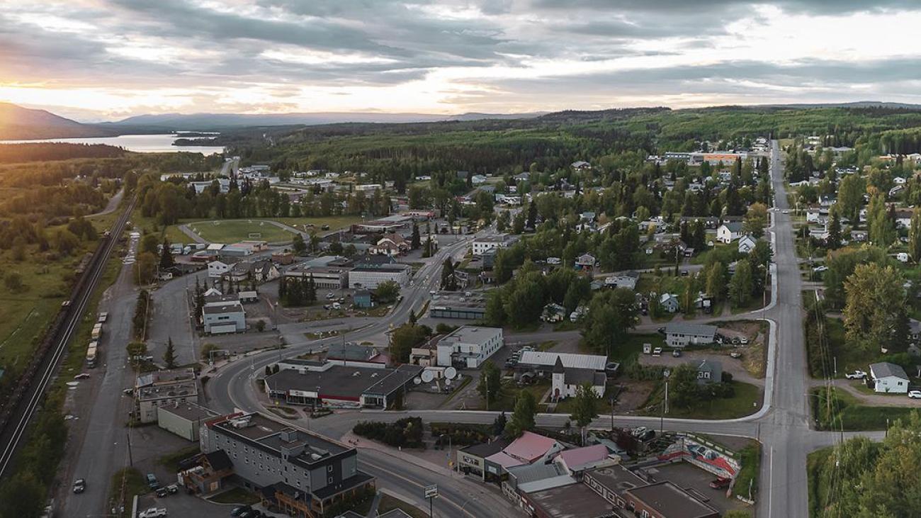 Small town aerial view at sunset with greenery and cloudy sky